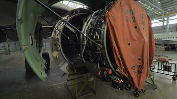 Disassembled jet engine in repair hangar video