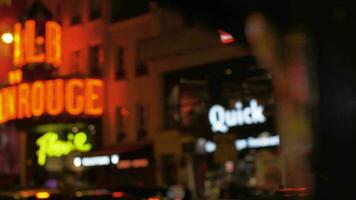 Illuminated Moulin Rouge in night Parisian street, France video