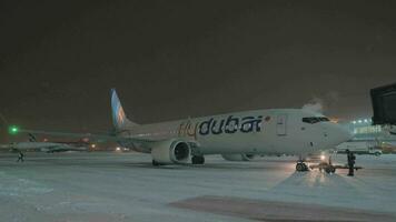 Flydubai aircraft in Sheremetyevo Airport at winter night, Moscow video