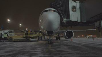 Deboarding and unloading luggage from arrived plane video