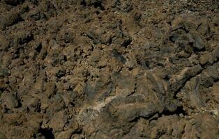 original marrón natural antecedentes de volcánico congelado lava en de cerca foto