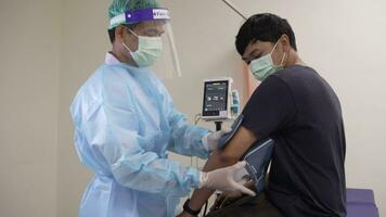 Doctor male checks blood pressure with blood pressure and heart rate monitor with a digital pressure gauge in the hospital. Cardiology, medical equipment, and healthcare awareness concept video