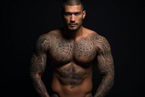 Confident man with muscular body tattooed on black background. photo