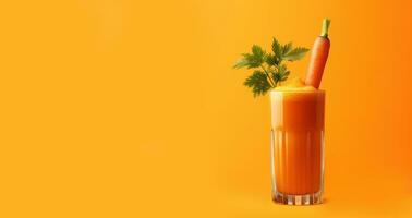 A glass of fresh carrot juice on a yellow background with space for text. photo