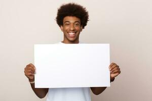Happy young black man holding blank white banner sign, isolated studio portrait. AI Generated photo
