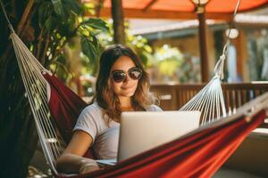 Woman using laptop outdoor. Young beautiful girl in a hammock and working on computer. Freelance, summer, enjoy life, student lifestyle, distance studying, travel vacations. AI Generated photo