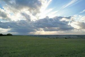 High Angle Panoramic Landscape View of British Agricultural Farms at Countryside Landscape of Sharpenhoe Clappers, Luton City of England UK. Footage Captured on August 19th, 2023 photo