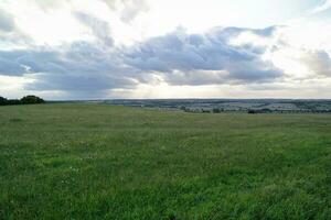 High Angle Panoramic Landscape View of British Agricultural Farms at Countryside Landscape of Sharpenhoe Clappers, Luton City of England UK. Footage Captured on August 19th, 2023 photo