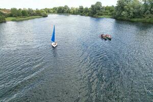 High Angle footage of People are Boating at Caldecotte Lake Located at Milton Keynes City of England Great Britain UK. The Aerial Landscape Was Captured on August 21st, 2023 with Drone's Camera photo