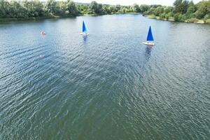 alto ángulo imágenes de personas son paseo en barco a caldecotta lago situado a milton Keynes ciudad de Inglaterra genial Bretaña Reino Unido. el aéreo paisaje estaba capturado en agosto 21, 2023 con drones cámara foto