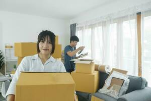 Asian young happy new married couple moving to their new house or real estate. photo