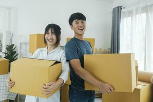 Asian young happy new married couple moving to their new house or real estate. photo