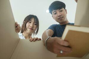 Asian young happy new married couple moving to their new house or real estate. photo