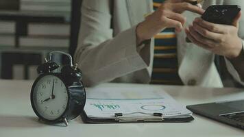 Female hand on the alarm clock a red color stands in the office on the table showing eight o'clock in the morning or evening AM PM. video