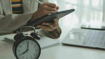 Female hand on the alarm clock a red color stands in the office on the table showing eight o'clock in the morning or evening AM PM. video