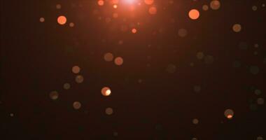 Abstract background of yellow orange gold glowing particles and bokeh dots of festive energy magic photo