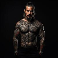 Confident man with muscular body tattooed on black background. photo