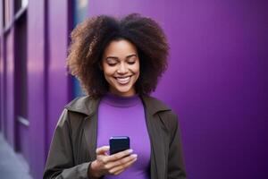 woman with phone on purple background . photo