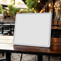 High quality photo of big tablet with blank screen on the table, perfect to create mockup preview