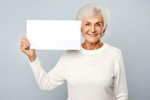 Happy mature senior woman holding blank white banner sign, isolated studio portrait. AI Generated photo