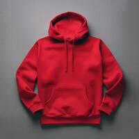 Blank red hoodie lying on the table, photographed from above photo