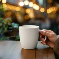 AI generative Women hand holding a white coffee mug, close - up, with blur background of cafe photo