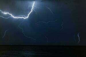 Bolt of lightening in a night sky photo