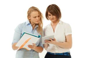 Two businesswomen looking at tablet photo