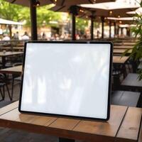 High quality photo of big tablet with blank screen on the table, perfect to create mockup preview