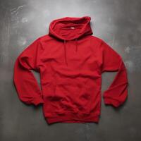 Blank red hoodie lying on the table, photographed from above photo