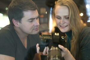 Young people looking through the photos on camera