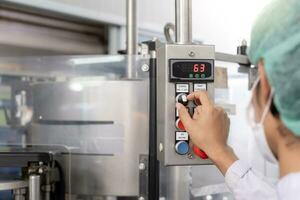 quality supervisor or food or beverages technician change parameter and condition control food or beverages before send product to the customer. Production leader recheck machine and productivity. photo