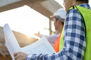 inspector or engineer is inspecting construction and quality assurance new house. Engineers or architects or contactor work to build the house before handing it over to the homeowner photo
