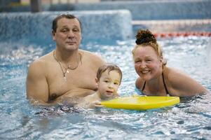 Grandparents and a grandson in the swimming pool photo