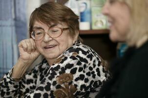 Senior lady chatting to a younger woman photo