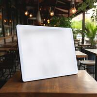 High quality photo of big tablet with blank screen on the table, perfect to create mockup preview