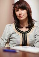 Attractive woman sitting in the office photo