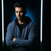 photo of handsome man with blue light on black background, generative AI