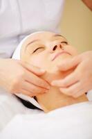 Massage of face at beauty treatment salon photo