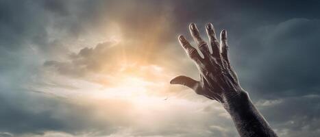 Zombie hand rising out of a graveyard in spooky night. Halloween concept. photo