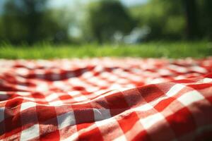 Red and white plaid picnic blanket on top of a green field in sunny day on grass of lawn in summer park. Blurred Background. Generative AI photo