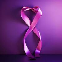 A pink ribbon on a purple background. Breast Cancer Month. photo