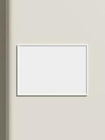 Thin rectangular frame hanging on a white textured wall mockup. photo