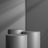 Elegant black cylinder stand for product placement mockup. Darkmetal podium exhibition scene background. Minimal platform showroom with shadow. photo