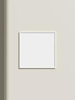 Thin rectangular frame hanging on a white textured wall mockup. photo