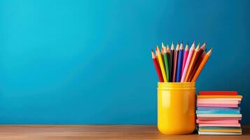 A brightly colored pencil case surrounded by school supplies background with empty space for text photo