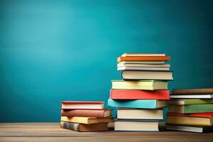 A colorful stack of textbooks on a desk background with empty space for text representing back-to-school themes photo