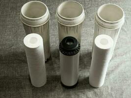 Three clean water filters. Replacing multi-stage water filter cartridges. photo