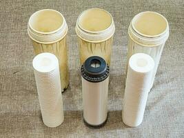 Three clean water filters. Replacing multi-stage water filter cartridges. photo