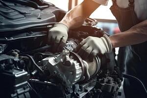 Professional mechanic working in auto repair shop. Car service and maintenance concept. photo